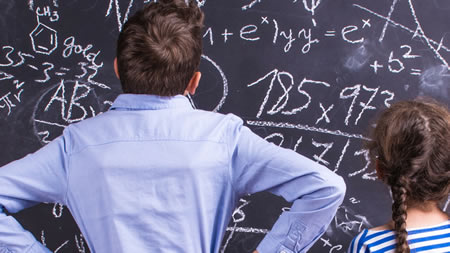 Young Student Overwhelmed by Equations on Chalkboard