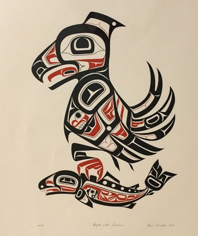 An eagle holding a salmon in tribal native american style design